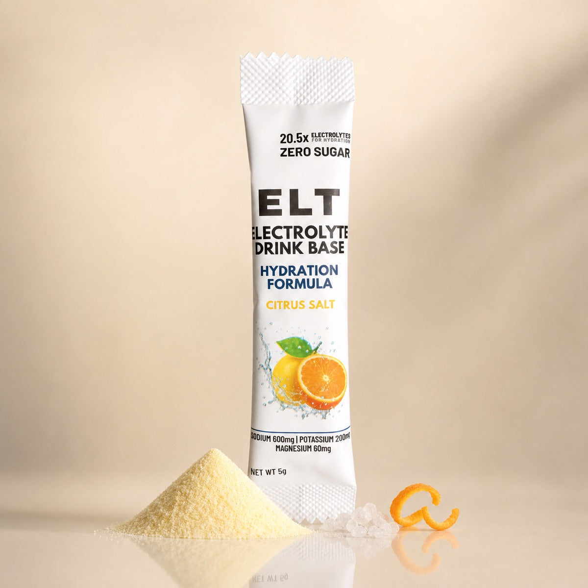 ELT sachet standing behind a neat cone of pale citrus electrolyte powder, salt pearls and a curl of orange zest
